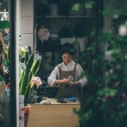 woman standing beside the table