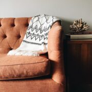 white and black textile on brown couch