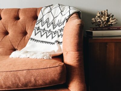 white and black textile on brown couch